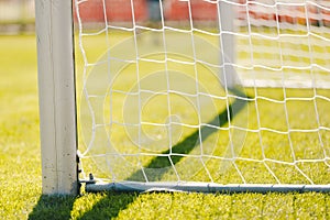 Net of a soccer goal. Soccer or football goal net covered with summer sunlight