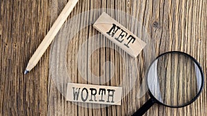 NET WORTH words on wooden building blocks on the wooden background