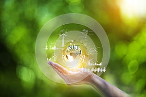 net zero concept. Hand holding bulb with net zero icon. carbon neutral concept. Dusty city environment PM 2.5 background. Climate-