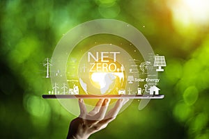 net zero concept. Hand holding bulb with net zero icon. carbon neutral concept. Dusty city environment PM 2.5 background. Climate-