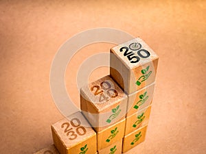Net zero plan 2050. Reduce CO2 emissions reduction, limit climate change concept. 2050 years target icon on wood cube blocks