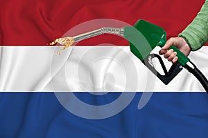 NETHERLANDS flag Close-up shot on waving background texture with Fuel pump nozzle in hand. The concept of design solutions. 3d