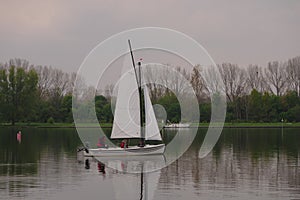 Netherlands, Roermond, Maasplassen, on the lake a Valk Jolle, a small open sailing boat with gaff sails