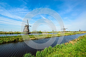 The Netherlands rural landscape with famous windmill in Kinderdijk museum in Holland. Sunny summer day in countryside