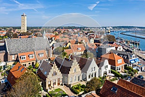 Brandaris lighthouse and Westerkerk, harbour and historical houses of West-Terschelling town. West Frisian Islands. photo