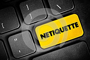 Netiquette is a set of rules that encourages appropriate and courteous online behavior, text concept button on keyboard photo