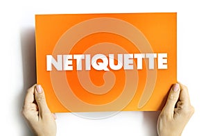 Netiquette is a set of rules that encourages appropriate and courteous online behavior, text concept on card photo