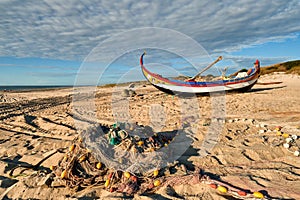 Nets and colorful fishing boats on the sand