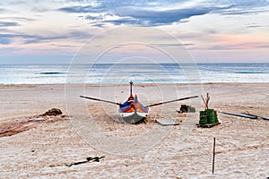 Nets and colorful fishing boats on the sand