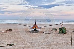 Nets and colorful fishing boats on the sand