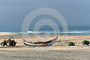 Nets and colorful fishing boats on the sand