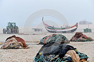 Nets and colorful fishing boats on the sand