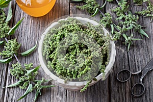 Nettle seeds in a bowl with a jar of honey photo
