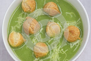 Nettle soup with peas puff in bowl closeup selective focus