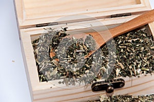 Nettle tea in a wooden box and retro wooden spoon photo