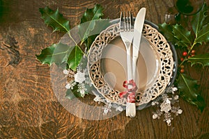 Netural, scandinavian style christmas dinner table setting: simple wooden table with silverware photo