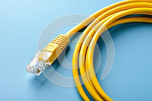 Network cable on blue background close up