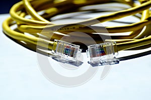 Network cable closeup with RJ45 connection. Ethernet network. clear vinyl plugs.