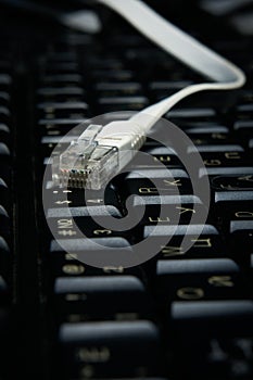 Network cable on keyboard, internet, worldwide network.