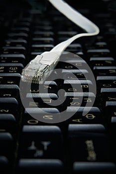 Network cable on keyboard, internet, worldwide network.