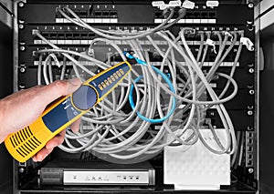 Network cable tester detail. Measuring probe in hand of expert on black and white background