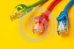 Network cable on yellow background studio shot close up