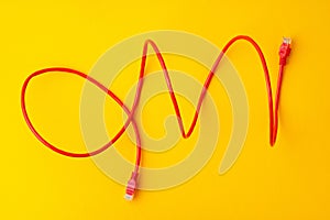 Network cable on yellow background studio shot close up