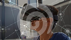 Network of connections with schoolboy wearing VR headset