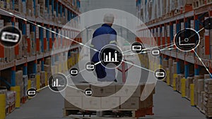 Network of digital icons against rear view of senior male worker pulling a pallet at warehouse