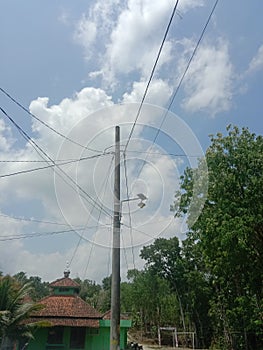 Network of electric cables in electric poles with A clear blue sky in the afternoon