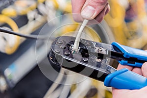 Network engineer working in server room. Connecting network cables to switches