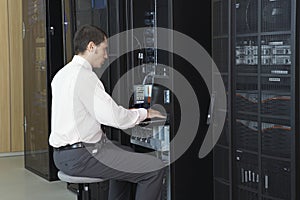 Network Engineer Working In Server Room