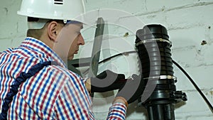 A network engineer works with optical fiber equipment