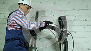 A network engineer works with optical fiber equipment