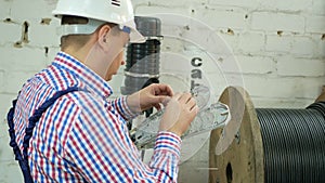 A network engineer works with optical fiber equipment