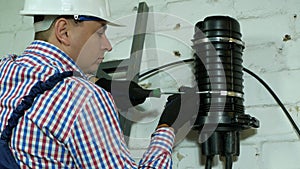 A network engineer works with optical fiber equipment