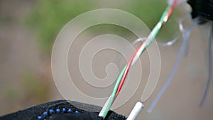 A network engineer works with optical fiber equipment