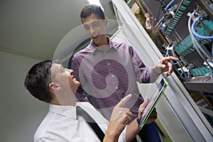 Network engineers in server room