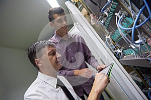 Network engineers in server room