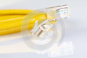 Network ethernet cable with RJ45 connectors isolated on white background. UTP Cable or LAN Cable. yellow color on white background