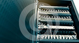 Network ethernet cables connect to switch server rack in data center hub of university, wires management on the interface panel