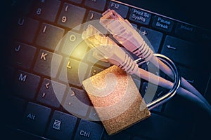 Network ethernet cables in padlock on black computer keyboard. Internet data privacy information security concept. Toned image