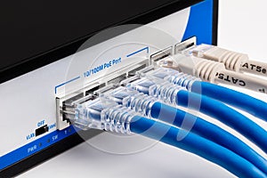 Network router with blue and grey cables connected. Close-up