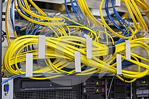 Network server room routers with fusebox panel. Neatly twisted wires. Datacentre interface and equipment. Network and technology photo