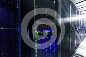 Network servers in a data center. Tier III carrier neutral data center. Server rooms.