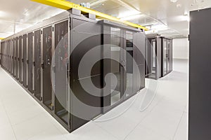 Network servers in a data center. Tier III carrier neutral data center. Server rooms.