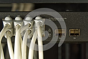 Network switch and ethernet cable in rack cabinet. Network connection technology thrue cat6 and cat5 wires. Network