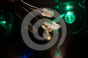 Network switch and ethernet cables, symbol of global communications. Colored network cables on dark background with lights and smo