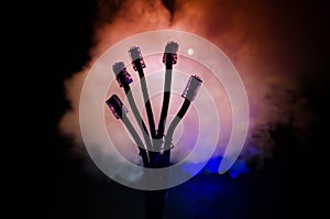 Network switch and ethernet cables, symbol of global communications. Colored network cables on dark background with lights and smo