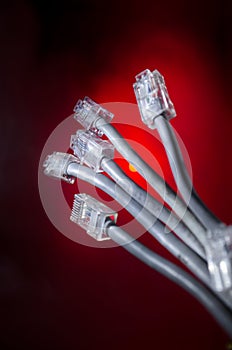 Network switch and ethernet cables, symbol of global communications. Colored network cables on dark background with lights and smo